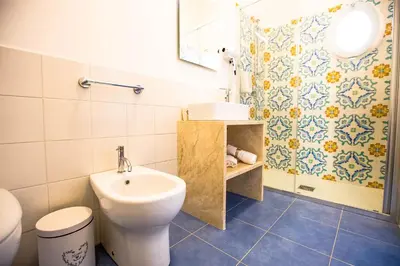 a bathroom with a toilet and a sink and a shower at Sciabika Home - Edificio Egadi in Castellammare del Golfo