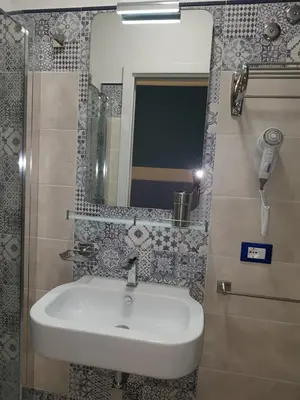 a bathroom with a sink and a mirror at B&B Aloe Comfort Rooms in San Vito lo Capo