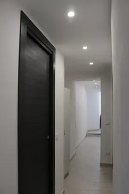 a hallway with a black door in a building at Le Torri dell'acqua in Palermo