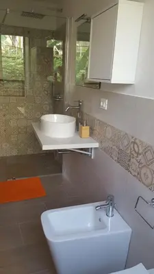 a bathroom with a white sink and a mirror at Le Torri dell'acqua in Palermo