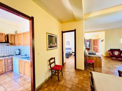 a kitchen with a table and chairs in a room at Villa Giada in Carini