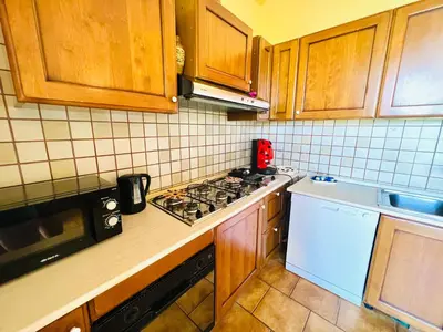 a kitchen with wooden cabinets and a stove top oven at Villa Giada in Carini