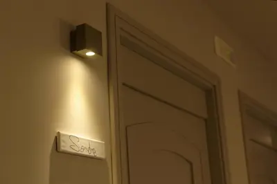 a door with a sign next to a mirror at B&B Questa casa non e'un albergo in Palermo