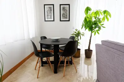 a black table and chairs in a living room at B&B Questa casa non e'un albergo in Palermo