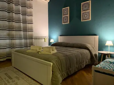 a bedroom with a bed with two pillows on it at Casa nel Vicolo in Palermo