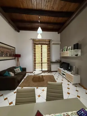 a living room with a couch and a table at Casa nel Vicolo in Palermo