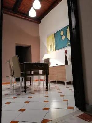 a living room with a piano and a bed at Casa nel Vicolo in Palermo