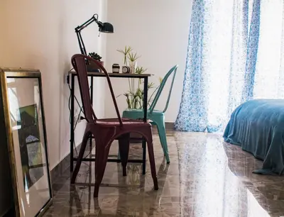 a desk with a chair and a lamp in a room at Be Central Rooms in Palermo