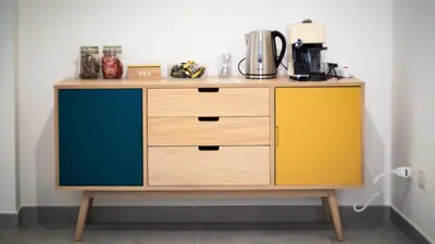 a wooden cabinet with yellow and blue doors at Be Central Rooms in Palermo