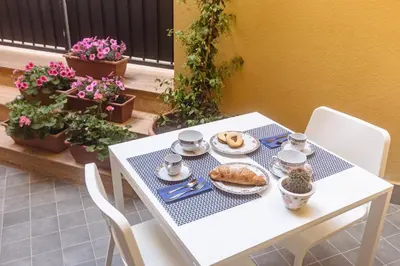 a white table with a plate of food on it at B&B Medusa in Santa Flavia