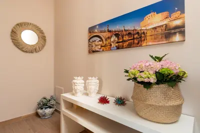 a room with a table with a vase of flowers at B&B Medusa in Santa Flavia