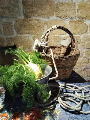 a basket and a basket of vegetables on a table at B&B Santa Caterina in Palermo