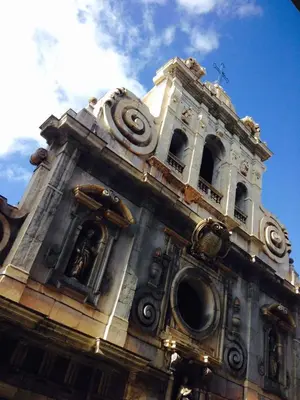 a tall building with a clock tower on top at B&B Santa Caterina in Palermo