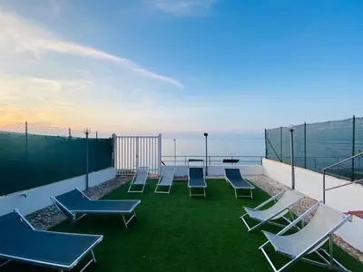 a group of chairs sitting on top of a roof at Sfondo Blu Villa sul mare in Trabia