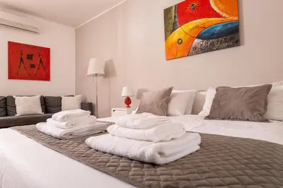 a bedroom with a bed with white towels on it at Madinah apartments in Palermo