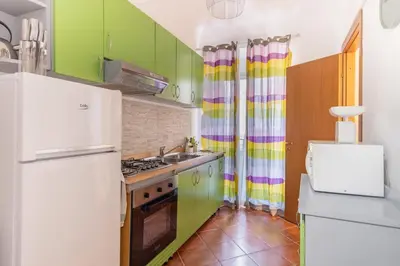a kitchen with green cabinets and a white refrigerator at Madinah apartments in Palermo