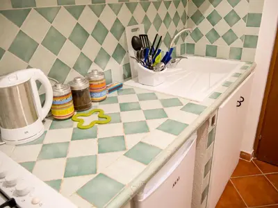 a kitchen with a checkered counter top with a sink at Madinah apartments in Palermo