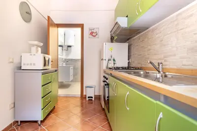 a kitchen with green cabinets and a sink at Madinah apartments in Palermo