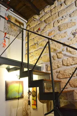 a stone wall with a staircase in a room at Il Drago e la Fenice in Palermo