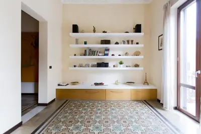 a room with white shelves and a rug at Il Drago e la Fenice in Palermo