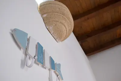 a hat hanging on a wall with signs on it at Centro Casa Monteleone in Palermo