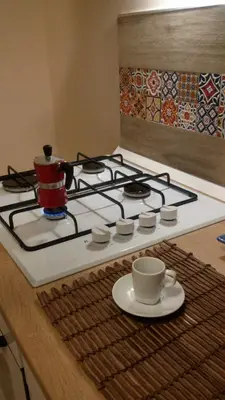 a stove top with a cup of coffee on it at Alla Casetta in Palermo