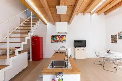 a kitchen with a sink and a red refrigerator at Il Sonno dei Giusti Apartment by DomuSicily in Palermo