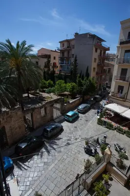 a group of cars parked in a parking lot at Il Sonno dei Giusti Apartment by DomuSicily in Palermo