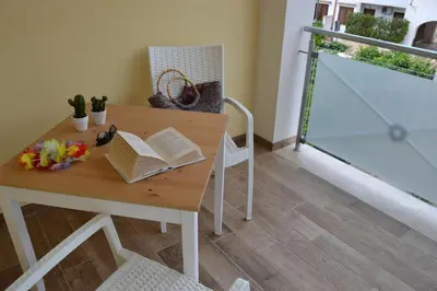 a table with a book on it with a chair at B&B Vivere San Vito Lo Capo in San Vito lo Capo