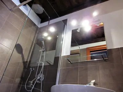 a bathroom with a shower and a sink and a mirror at icalderai in Palermo
