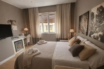 a bedroom with a large bed with towels on it at Maxim in Palermo