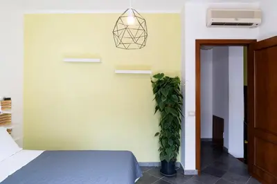 a bedroom with a bed and a potted plant at Khalisa Home in Palermo
