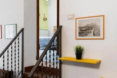 a stairway with a picture and a plant on a wall at Khalisa Home in Palermo