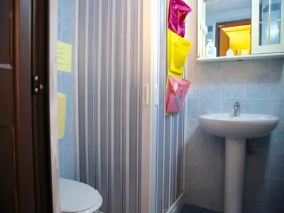 a bathroom with a sink and a toilet and a mirror at Acasaammari in Campofelice di Roccella