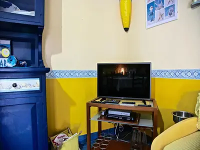 a living room with a tv on a table at Acasaammari in Campofelice di Roccella