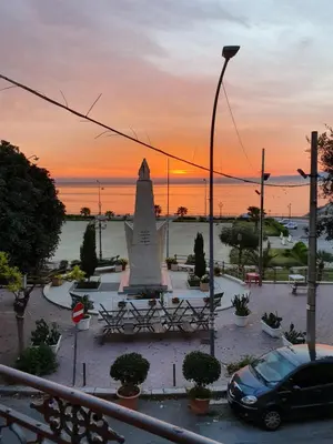 a car parked in front of a monument at sunset at Pandora in Porticello