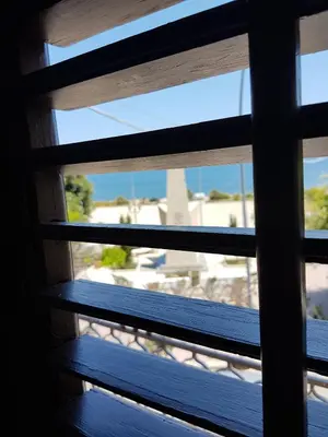 a view of a window with a view of the beach at Pandora in Porticello