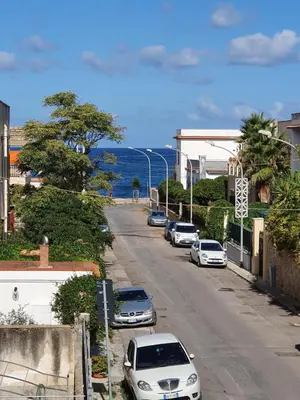 a street with cars parked on the side of the road at MarieRose House Sferracavallo in Sferracavallo