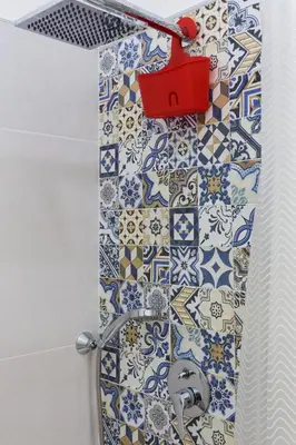 a bathroom with a shower with blue and white tiles at dallo Zio Totò in Palermo