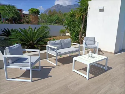 a group of chairs and a table on a patio at Villa Flo in Castellammare del Golfo