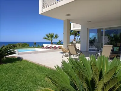 a villa with a swimming pool and a house at Villa Flo in Castellammare del Golfo