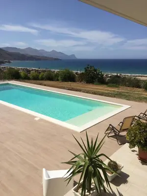 a swimming pool with a view of the ocean at Villa Flo in Castellammare del Golfo