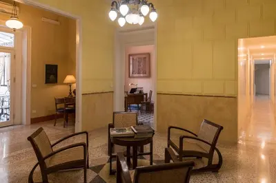 a room with chairs and a table in a room at palazzo pantaleo in Palermo