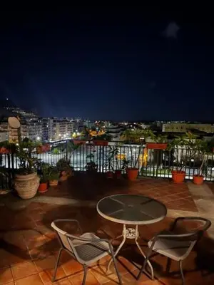 a table and chairs on a balcony at night at Incantevole E A Due Passi Dal Centro in Palermo