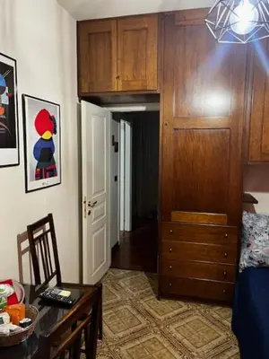 a room with a bedroom with a dresser and a table at Incantevole E A Due Passi Dal Centro in Palermo