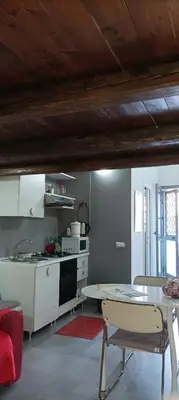 a kitchen with a table and a counter top at La Casetta Di Marta ai Quattro Canti in Palermo