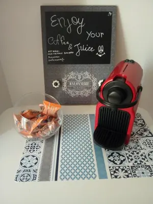 a table with a red coffee maker and a bowl of carrots at Porta Nuove Vacanze in Palermo