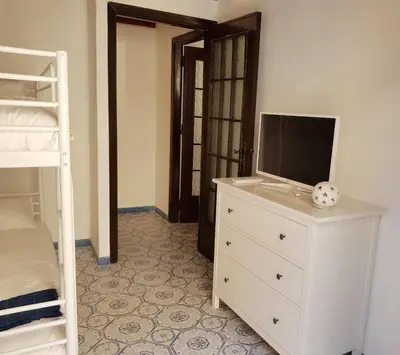 a bedroom with a tv on a dresser and a bunk bed at Il Grazioso Giardinaccio in Palermo