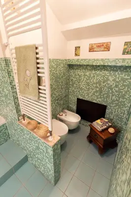 a bathroom with a toilet and a sink at Vista Cattedrale in Palermo