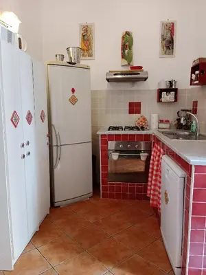 a kitchen with a white refrigerator and a stove at Casa Sicana in Palermo